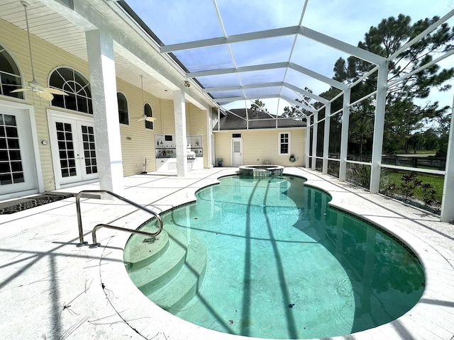 view of swimming pool featuring a lanai, french doors, a pool with connected hot tub, and a patio