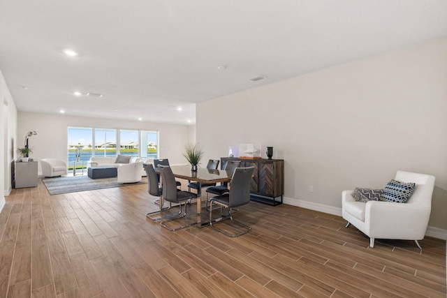 dining space featuring recessed lighting, baseboards, and wood finished floors