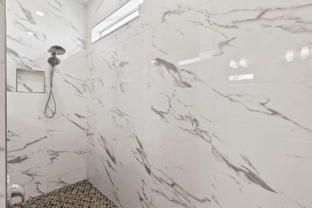 bathroom with a marble finish shower