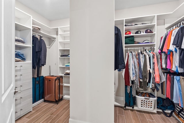 walk in closet featuring wood tiled floor