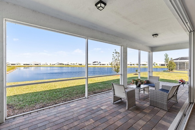 sunroom / solarium with a water view