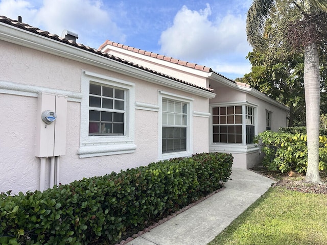 view of side of property with stucco siding