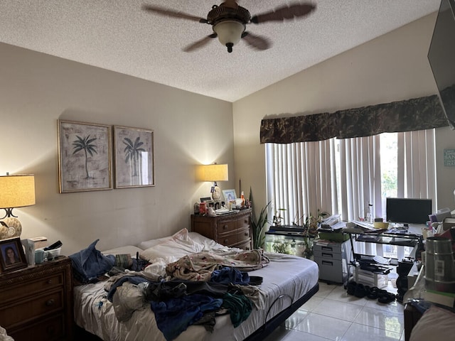 bedroom with light tile patterned floors, ceiling fan, a textured ceiling, and lofted ceiling