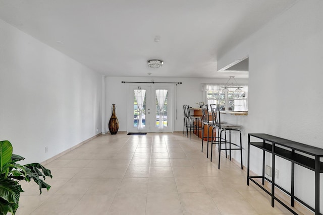 interior space with french doors and baseboards