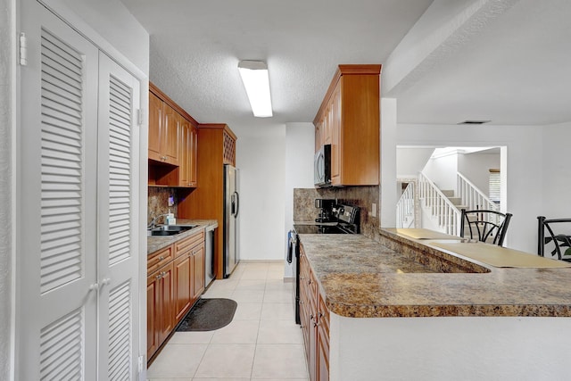 10476 SW 52nd St, Cooper City, FL 33328 - kitchen with appliances with stainless steel finishes, a sink, tasteful backsplash, light tile patterned floors, and a textured ceiling