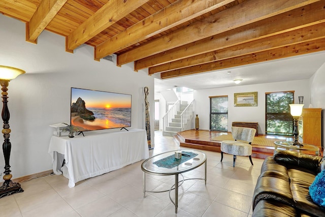 tiled living area featuring beamed ceiling, wooden ceiling, stairs, and baseboards