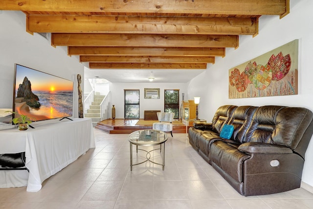 living area featuring stairs, beamed ceiling, and light tile patterned flooring