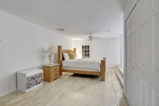 bedroom featuring visible vents, baseboards, and a ceiling fan