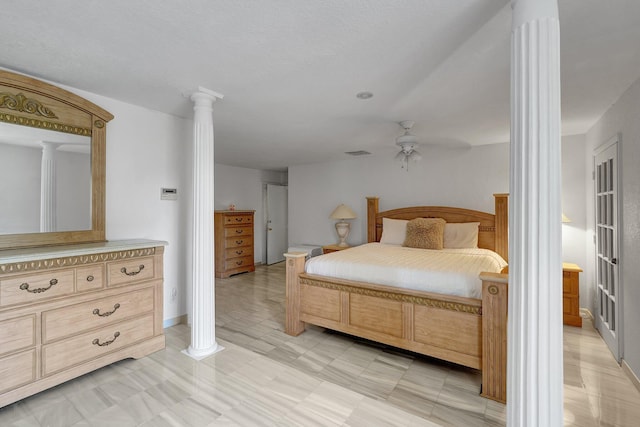 bedroom with visible vents, a ceiling fan, and ornate columns