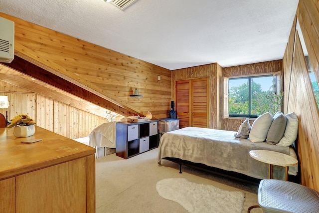 carpeted bedroom featuring wooden walls, an AC wall unit, a textured ceiling, and visible vents