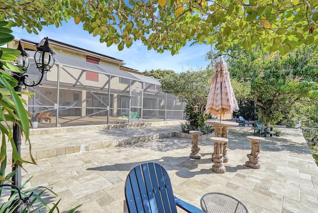 view of patio featuring a lanai