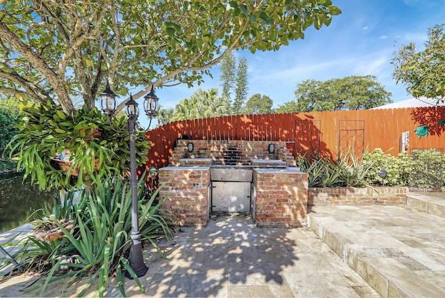 view of gate featuring a patio area and fence