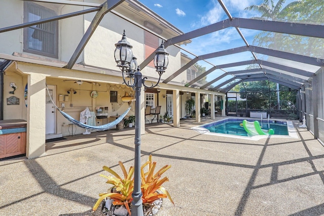 outdoor pool with glass enclosure and a patio area