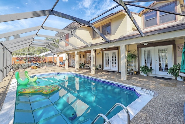 outdoor pool featuring a fenced backyard, french doors, a lanai, and a patio