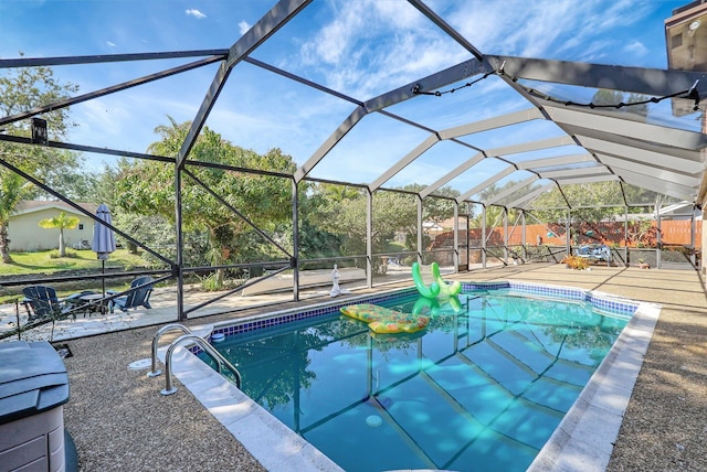 view of swimming pool featuring a lanai, a patio area, and a fenced in pool