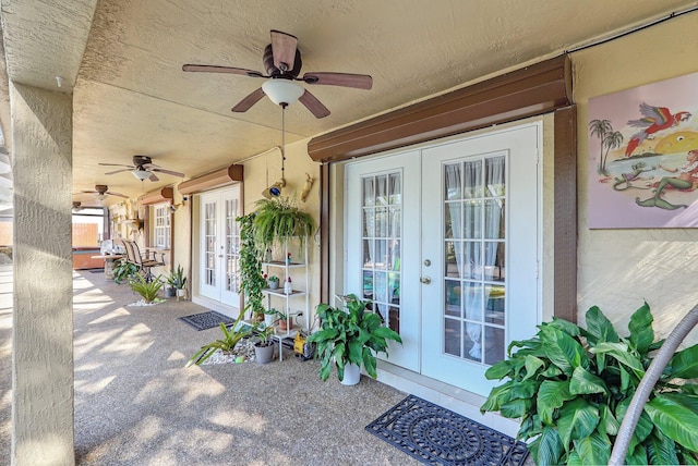 view of exterior entry with french doors and a ceiling fan