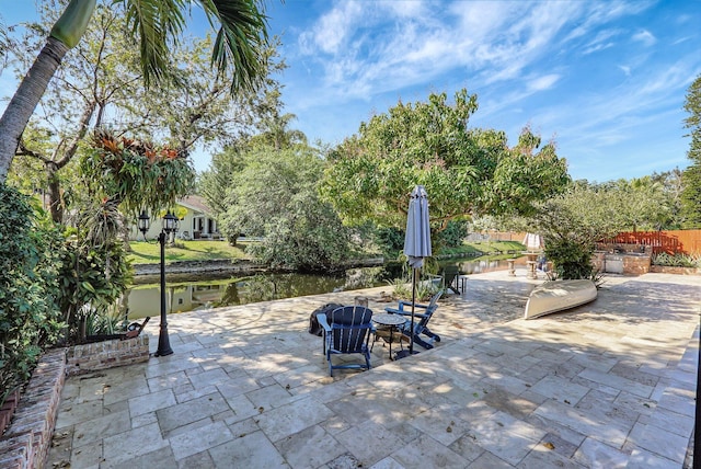 view of patio / terrace with a fire pit and a water view