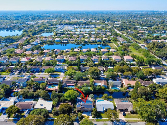 drone / aerial view with a residential view and a water view