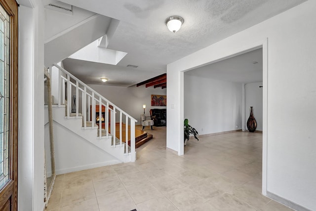 10476 SW 52nd St, Cooper City, FL 33328 - stairway with tile patterned flooring, baseboards, a textured ceiling, and beamed ceiling