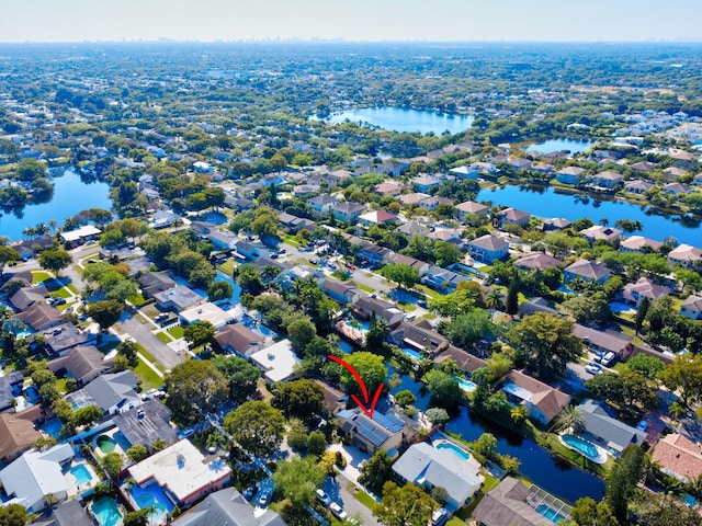 drone / aerial view featuring a residential view and a water view