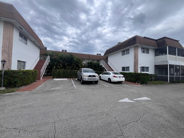 uncovered parking lot featuring stairs