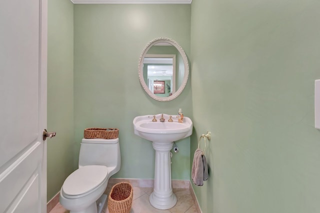 bathroom featuring tile patterned floors, baseboards, and toilet