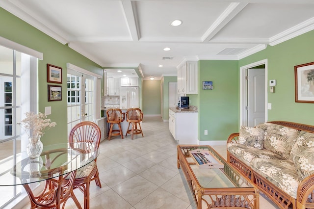 living area with light tile patterned floors, baseboards, visible vents, ornamental molding, and french doors