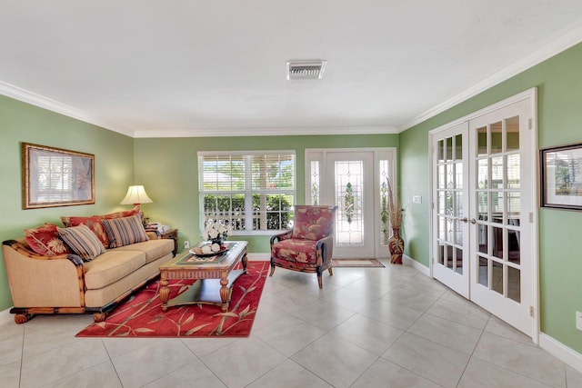 tiled living room with french doors, baseboards, visible vents, and crown molding