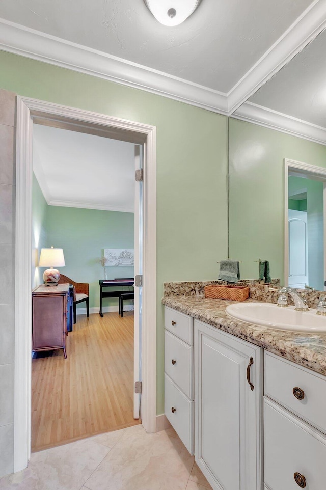 bathroom with vanity, crown molding, and tile patterned flooring