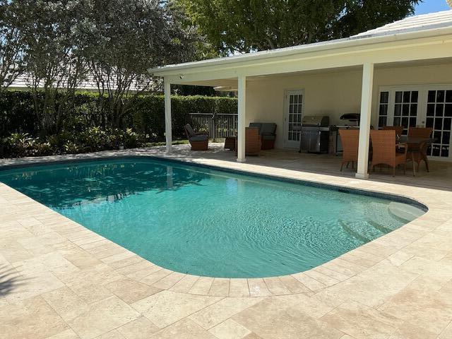 view of swimming pool with a fenced in pool, a patio, area for grilling, and fence