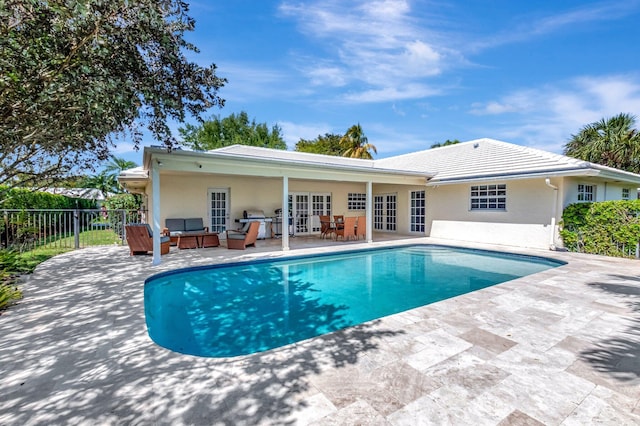 view of pool featuring a fenced in pool, fence, french doors, a patio area, and an outdoor hangout area