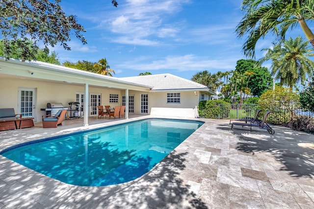 view of swimming pool featuring a patio area, a fenced in pool, french doors, and fence