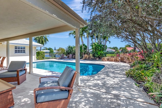 view of swimming pool featuring a patio area, a fenced in pool, and fence