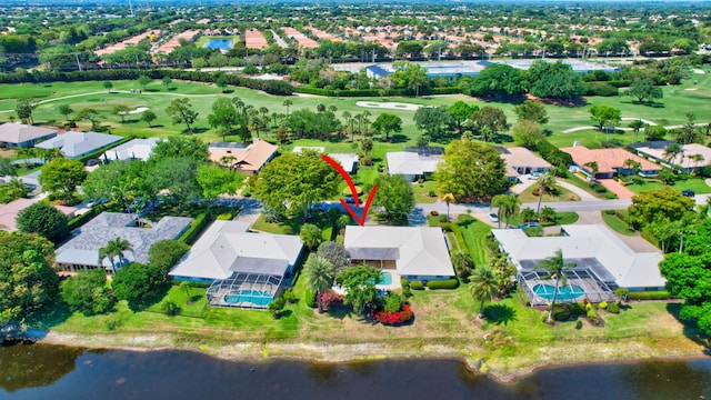 bird's eye view featuring golf course view, a water view, and a residential view