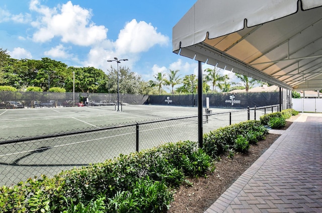 view of tennis court with fence