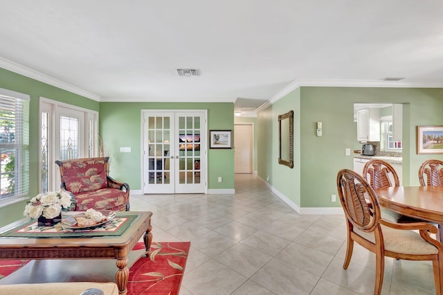 living room featuring visible vents, crown molding, baseboards, french doors, and light tile patterned flooring