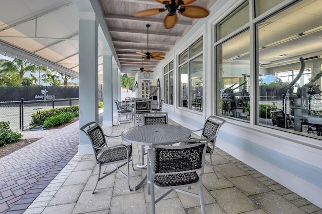 view of patio / terrace featuring outdoor dining area, fence, and ceiling fan