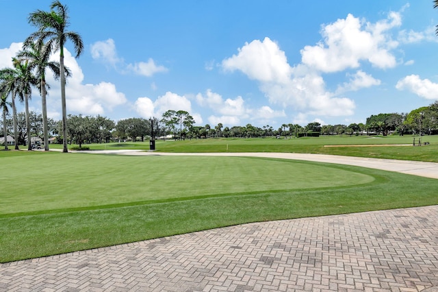 view of community with a lawn and golf course view