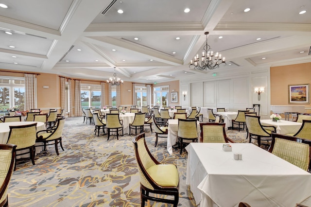 dining room with beam ceiling, a decorative wall, a notable chandelier, and light colored carpet