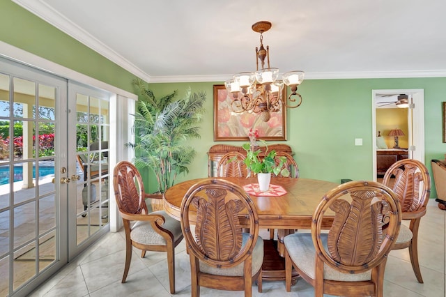 dining area featuring a chandelier, french doors, crown molding, and light tile patterned flooring