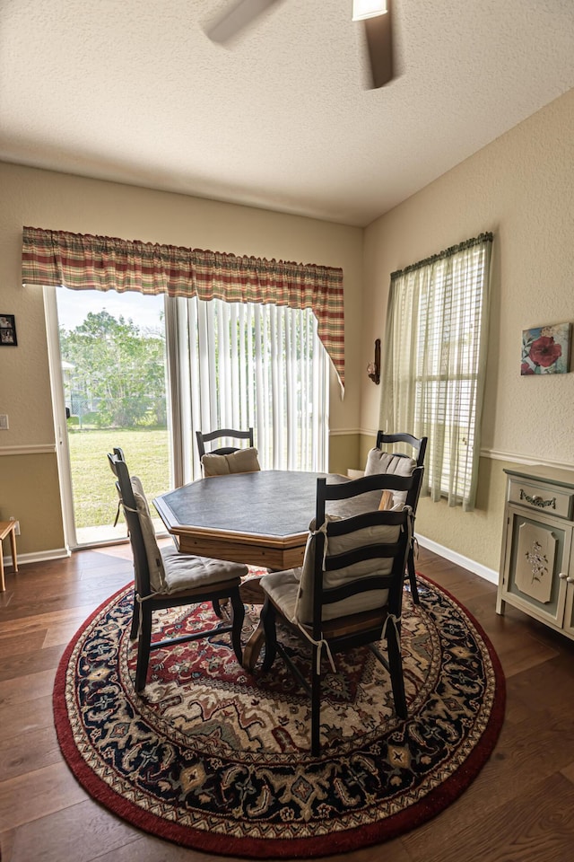 6496 NW Groveland Ter, Port Saint Lucie, FL 34986 - dining room featuring baseboards, a textured ceiling, dark wood-style floors, and a textured wall