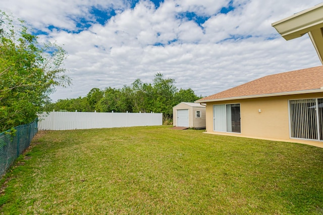 6496 NW Groveland Ter, Port Saint Lucie, FL 34986 - view of yard with a storage unit, a fenced backyard, and an outdoor structure