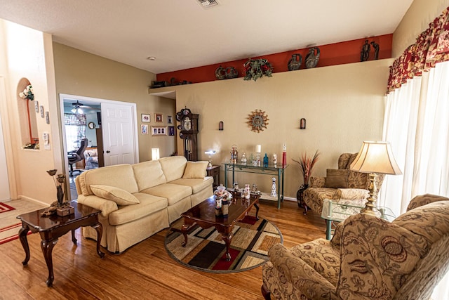 6496 NW Groveland Ter, Port Saint Lucie, FL 34986 - living area with visible vents, baseboards, a ceiling fan, and wood finished floors