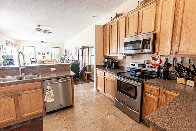 6496 NW Groveland Ter, Port Saint Lucie, FL 34986 - kitchen with light tile patterned flooring, a sink, ceiling fan, stainless steel appliances, and dark countertops