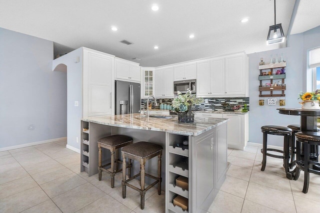 6346 Sand Hills Cir, Lake Worth, FL 33463 - kitchen with light stone countertops, stainless steel appliances, tasteful backsplash, a sink, and light tile patterned floors