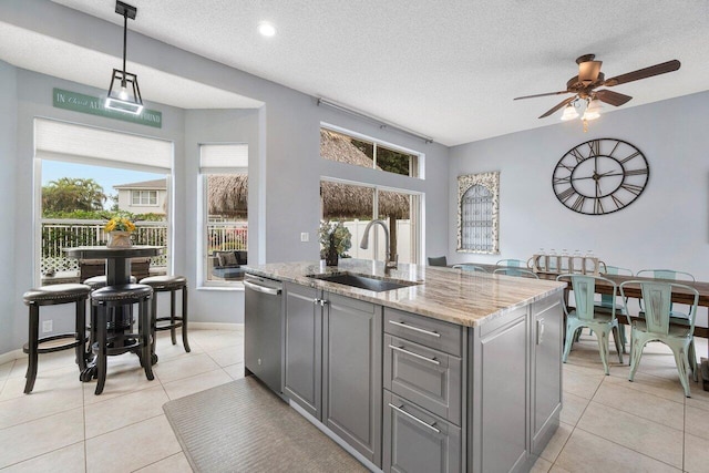 6346 Sand Hills Cir, Lake Worth, FL 33463 - kitchen with light tile patterned flooring, a ceiling fan, a sink, gray cabinetry, and stainless steel dishwasher