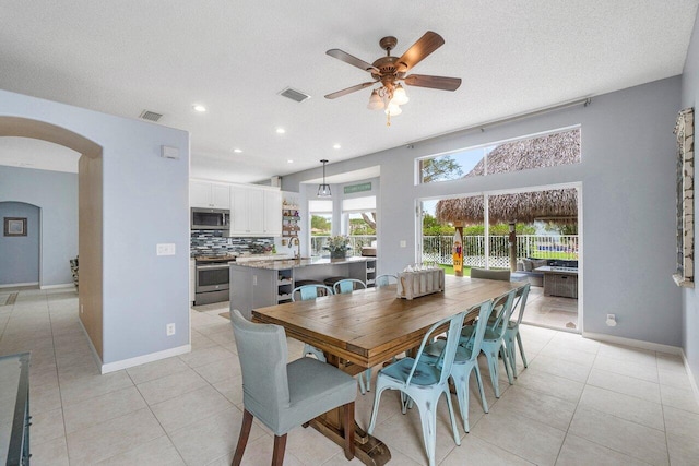 6346 Sand Hills Cir, Lake Worth, FL 33463 - dining area featuring light tile patterned flooring, visible vents, arched walkways, and ceiling fan