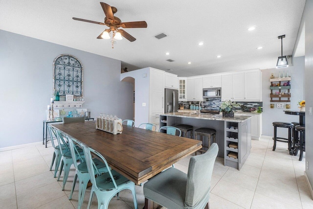 6346 Sand Hills Cir, Lake Worth, FL 33463 - dining area with visible vents, baseboards, a ceiling fan, arched walkways, and light tile patterned floors
