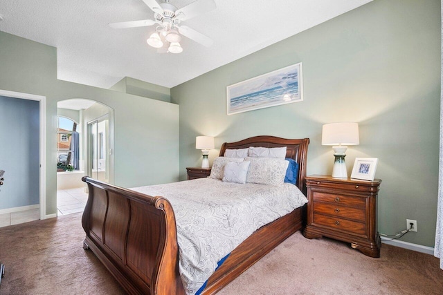 6346 Sand Hills Cir, Lake Worth, FL 33463 - carpeted bedroom featuring arched walkways, baseboards, ensuite bathroom, and ceiling fan