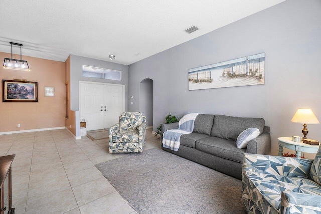 6346 Sand Hills Cir, Lake Worth, FL 33463 - living area with baseboards, a textured ceiling, light tile patterned flooring, arched walkways, and visible vents